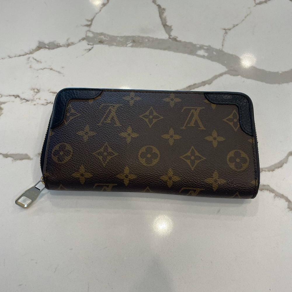 Louis Vuitton wallet with black accents  in great condition!